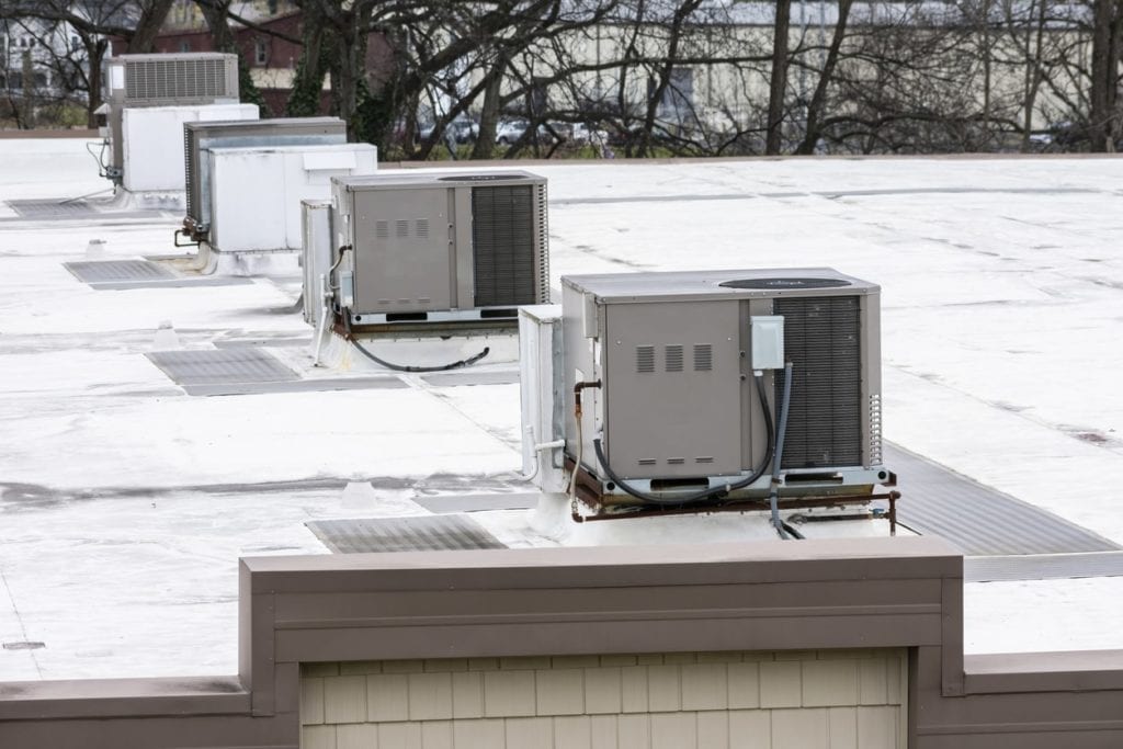 4 Rooftop RTU hvac units on a commercial rooftop building.