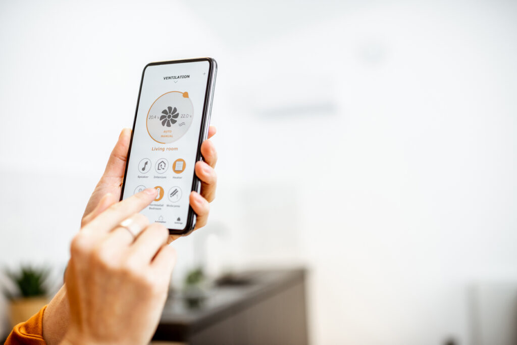 Controlling HVAC with smart building technology via a mobile app interface.