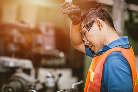 Manufacturing plant with overheated employees during heat wave
